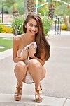 Cute brunette teen in a sexy white dress gets naked on the street