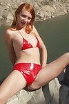 Amateur redhaired exhibitionist poses naked on the rocks beside