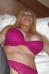 Big busted blonde Candy Manson slipping on her lingerie and stockings