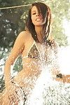 Destiny moody in a tiny bikini outdoors spraying her body with hose