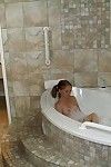Slippy teenage slut jerking off a thick boner in a foamy bath