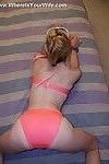 Blonde skinny housewife posing in pinky underwear in the bedroom