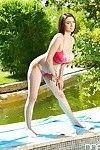 Busty solo babe Luna Amor modelling toned body outdoors in pink bikini
