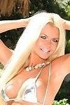 Very hot big breasted blonde MILF shows her hot body outdoors in very provocative and slutty bikini.