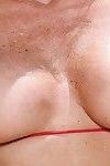 Older blonde woman Jodi West releasing big natural boobs from bikini in pool