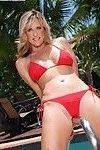 Older blonde woman Jodi West releasing big natural boobs from bikini in pool