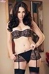 Wonderfully shaped brunette is standing in extremely lingerie