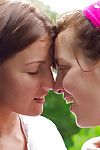Young chicks Gina J and Immie tongue kiss and lap hairy pussy outside