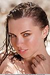 Brunette European beach girl Anita E showing firm tits & bald pussy on knees