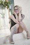 Inked babe in glasses revealing shaved pussy after shedding dress
