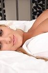 Busty blonde gets comfy on her bed
