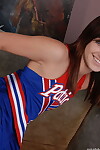 Teen cheerleader hikes up her uniform before toying and fingering her pussy