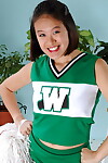 Amateur Asian freeing big tits and ass from beneath cheerleader uniform