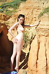 Solo girl Sam Bentley climbs the cliffs at beach to pose in the nude