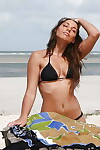 Cool babe Zafira posing in bikini and masturbating on the beach