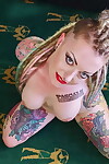 Heavily tattooed amateur Piggy Mouth removes a revealing dress to get naked