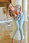 Fully clothed sweetie pulls down jeans on lawn before masturbating inside
