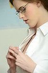 Skinny blonde bookworm in glasses getting nude in the classroom