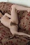 Amelia strips naked by her couch