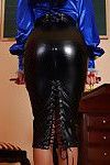 Fully clothed fetish MILF exposing her ample ass covered with latex skirt