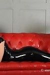 Beautiful blonde alessandra poses on a couch in skin tight shiny