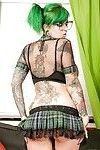 Glasses attired punker Sydnee Vicious showing off tattoos in pleated skirt