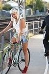 Girl with bleached blonde mullet riding bike with pantyless around town