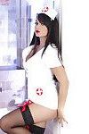 Steamy nurse in nylons taking off her uniform and spreading her pussy