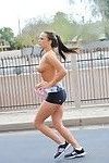 Jolie Femelle dans shorts affiche Son chaud sports Corps Nu dans public