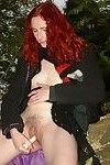 Amateur redhaired exhibitionist plays with her pussy outdoors on
