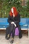 Amateur redhaired exhibitionist plays with her pussy outdoors on