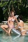 Gorgeous lesbians lustily lap and rub pink twats poolside