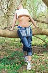 Stunning redhead babe Nikki removes her tight shirt in the woods