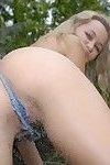 Topless blonde teen teasing in sexy very short shorts playing with water outdoor