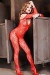 Glamorous pornstar in red lace bodystockings getting off with a dildo