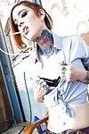 Tattooed alt chick in schoolgirl socks and outfit baring tiny tits