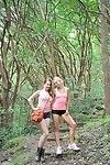 Two sexy lesbian chicks make out and spread their twats in the woods