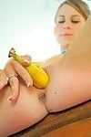 Fit solo girl inserting banana into shaved vagina while masturbating