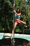 Bikini laden Krystal Webb does slow striptease around stripper pole outside