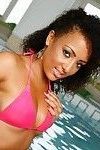 Exotic brunette in the pool in her pink bikini