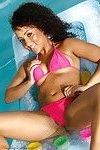 Exotic brunette in the pool in her pink bikini