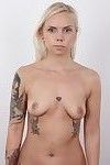 Tattooed amateur blonde poses nude