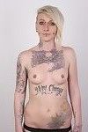 Tattooed blonde poses for photo camera