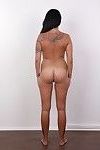 Tattooed brunette posing naked