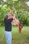 Amateur milf is bound and suspended from a tree