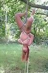 Amateur milf is bound and suspended from a tree