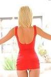 Stunning blonde teen strips off clingy red skirt to pose nude on stairs
