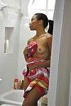 Ebony Adrian Maya undressing and taking shower in voyeur scene