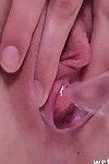 Masturbating babe pisses and teases her shaved pussy in close up