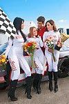 Three racing girls with shaved cunts are into CFNM groupsex outdoor